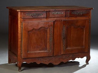French Provincial Louis XV Style Carved Cherry Sideboard, 19th c., the ogee edge canted corner rectangular top above three frieze drawers, over double