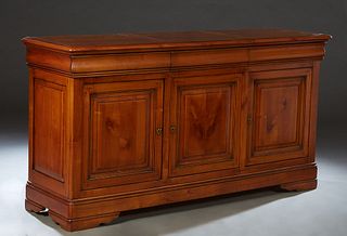 French Provincial Louis Philippe Carved Cherry Sideboard, 19th c., the rounded edge and corner top over three setback cavetto frieze drawers, above th