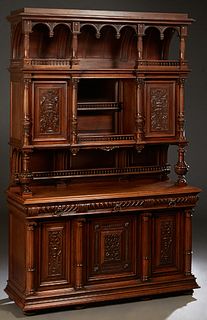 French Henri II Style Carved Walnut Buffet a Deux Corps, c. 1880, the stepped crown over an arched breakfront top with spindle galleries below, on a s