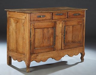 French Provincial Carved Poplar Louis XV Style Sideboard, 19th c., the ogee edge canted corner four board top over three frieze drawers with long iron