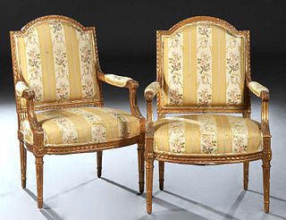 Pair of Louis XVI Style Gilt and Gesso Fauteuils, early 20th c., the arched curved upholsterted back over upholstered arms, to a bowed seat, on turned
