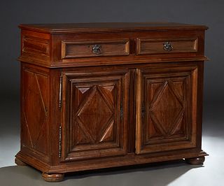 French Provincial Louis XIII Style Carved Walnut Sideboard, 19th c., the stepped rectangular top over two large frieze drawers above double cupboard d