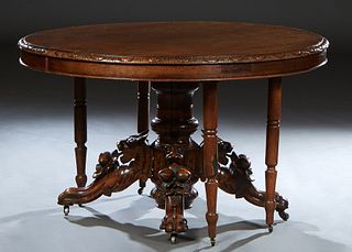 French Provincial Henri II Style Carved Oak Dining Table, c. 1880 the stepped sloping carved edge oval top, on a large central urn support with four r