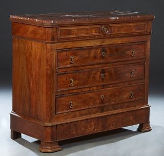 French Louis Philippe Carved Walnut Marble Top Commode, 19th c., the inset canted corner figured rouge marble over a frieze drawer, three deep drawers