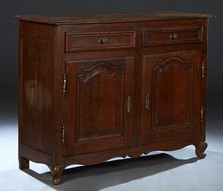 French Provincial Carved Oak Louis XV Style Sideboard, 19th c., the stepped rounded edge top with a rear plate groove, over two setback frieze drawers