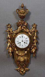 French Louis XVI Style Gilt Bronze Cartel Clock, late 19th c., with an urn surmount over a bow garland, above an enamel dial time and strike enamel di