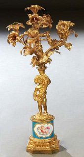 Sevres Style Gilt Bronze and Porcelain Four Light Figural Candelabra, early 20th c., the bronze mounted candelabra; with a Bleu Celeste porcelain stan