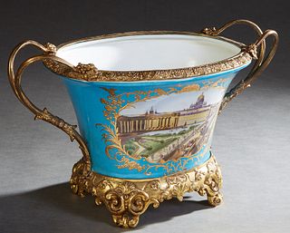 Sevres Style Gilt Bronze Mounted Porcelain Handled Center Bowl, 20th c., the sloping bleu de celeste sides with double curved bronze handles, and arch