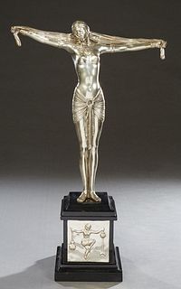 In the Manner of Dimitri Chiparus I886-1947), "Art Deco Dancer," late 20th/21st c., silver patinated bronze on a stepped black marble base, H.- 27 1/2