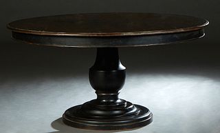 Tuscan Style Carved Mahogany Dining Table, 20th c., the rounded edge circular top over a wide skirt, on a large urn support to a stepped circular base