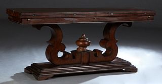 Unusual Tuscan Style Carved Mahogany Flip Top Sofa Table, 20th/21st c., the top with front and back fold out leaves, on a large central scrolled trest