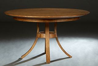Carved Mahogany Manhattan Dining Table, 20th/21st c., the circular top over a wide skirt, on a base with four splayed legs, H.- 30 in., Dia.- 54 in,
