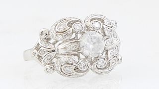 Lady's Platinum Dinner Ring, with a central .97 ct. round diamond, on a thick pierced scrolled top mounted with round and pave diamonds, diamond accen
