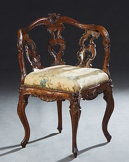 Italian Carved Walnut Louis XV Style Corner Chair, 20th c., the serpentine curved back rail over three pierced vertical splats, to a pointed cushioned