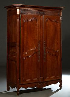 French Provincial Louis XV Style Carved Cherry Armoire, early 19 th c., the stepped canted corner crown over double two panel doors with long iron fic