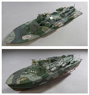Handmade Wooden Model of an Early Higgins PT Boat, painted in camo colors, together with a large Higgins deck, #34, H.- 10 in., W.- 32 in., D.- 8 3/4 