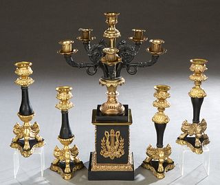 Gilt and Ebonized Bronze Five Piece Mantel Garniture, 20 th c., consisting of a six arm candelabra, on a square stepped plinth mounted with a gilt wre