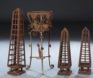 Four Pieces of Wrought Iron Garden Decorations, 20th/21st c., consisting of a pair of strapwork obelisks, a tall strapwork obelisk, and a citcular pla