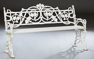 Cast Iron Garden Bench, 2o0th/21st c., the canted pierced back with grape and leaf decoration, over a three wooden plank seat, flanked by pierced scro