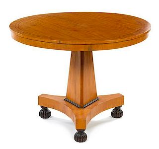 * A Biedermeier Parcel Ebonized Center Table Height 27 x diameter 37 inches.