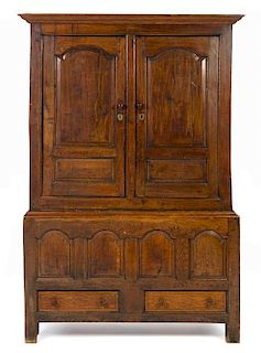 * An English Oak Cabinet on Stand Height 72 1/2 x width 50 1/4 x depth 21 inches.