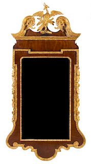 A George III Style Parcel Gilt Mahogany Mirror Height 58 x width 29 inches.