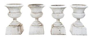 A Set of Four Victorian Iron Garden Urns Height 33 inches.