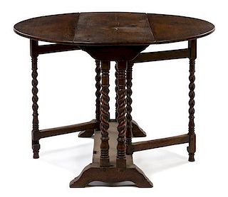 A Jacobean Style Oak Drop Leaf Table Height 28 x width 36 x depth 16 inches (closed).