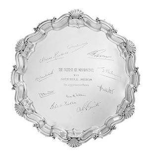 An Edward VII Silver Salver, Mappin & Webb, London, 1901, the undulating border with rocaille decoration and raised on three cla