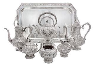 A Chinese Silver Tea Service, 19th/20th Century, comprising a kettle on lampstand, two coffee pots, a two-handled lidded sugar b