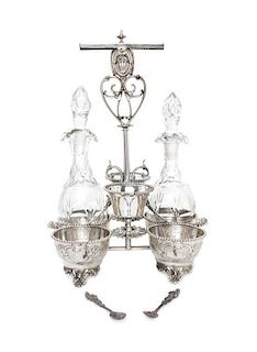 * An American Silver and Cut Glass Cruet Stand, Wood & Hughes, New York, NY, Late 19th Century, of handled form, having six comp