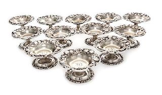 * A Set of Twelve American Silver Salts, Mauser Manufactring Co., New York, NY, each having a C-scoll rim with a foliate and ber