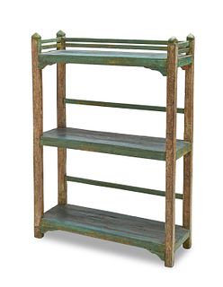 An rustic painted wood shelving unit