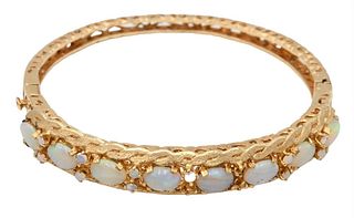 14K Gold Bangle Bracelet, set with opals, three small opals missing, 21.1 grams.
