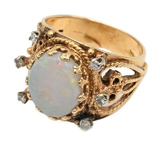 14 Karat Gold Ring, set with oval opal flanked by diamonds, size 7, 7.4 grams.