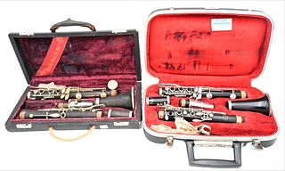 Two Clarinets, to include one made of wood, one Evette; both made in Paris, in cases.