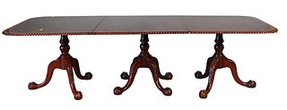 Reproduction Mahogany Triple Pedestal Dining Table, having rope edge and carved pedestals with ball and claw feet, along with two 20" leaves, late 20t