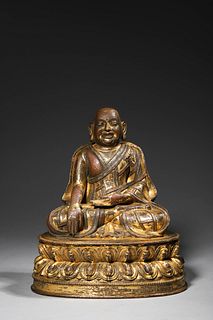 Ming: A gilt bronze Enlightened Monk Statue