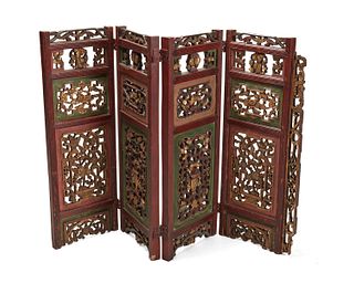 A Chinese carved wood folding screen
