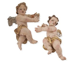 A pair of carved wood putti