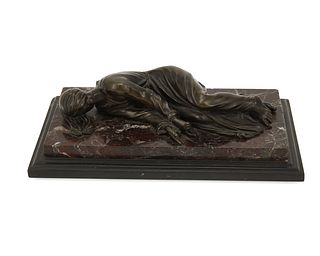 A Continental bronze sculpture of a recumbent figure