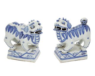 A pair of Chinese porcelain guardian lions