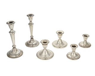 A group of weighted sterling silver candlesticks