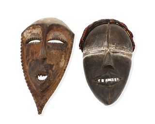 Two African carved wood figural masks