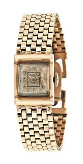 A lady's 14 karat gold wrist watch with integral bracelet