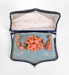 A Victorian carved coral brooch and earring set in its original box