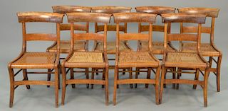 Set of eight figured maple chairs with caned seats.