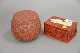 Two cinnabar boxes including round box with scrolling flowers and birds and a rectangle box with a Guanyin mounted on the top (as is...
