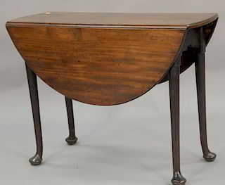 George II style mahogany table with oval drop leaves on turned legs ending in pad feet.  ht. 28 in.; open: 39" x 41"  Provenan...