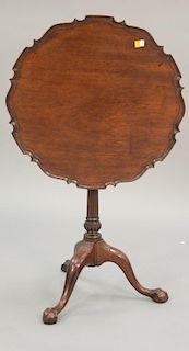 Custom mahogany piecrust tip table with ball and claw feet (ring missing in bird cage). ht. 27 1/2 in.; dia. 24 in.